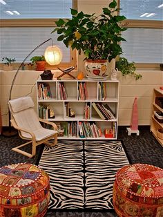 a living room filled with lots of furniture and bookshelves next to a window