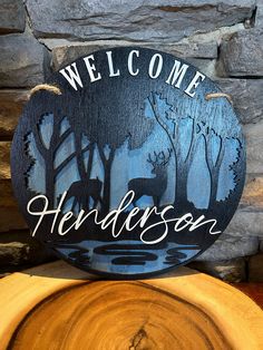 a wooden sign that says welcome to the wilderness with deer in the woods behind it