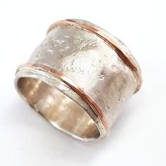 Wide and textured wedding ring. Unique wide wedding band for women. Some of our customers have said that the texture of the ring reminds them of the surface of the moon... This is a sterling silver band with 10k rose gold thin strips soldered on the edges and hammered. (Optional: edging strips can be both yellow, or one yellow and one rose gold - just contact us.) Width: 0.58 inch / 14.5 mm Thickness: 0.1 inch / 2.5 mm This listing is for sizes 4-13- Just convo me your size. For other sizes - pl Silver And Gold Wedding, Textured Wedding Ring, Three Tone Ring, Gothic Wedding Rings, Wedding Band For Women, Wide Wedding Bands, Real Jewelry, Gold And Silver Rings, Textured Ring