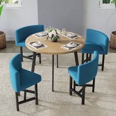 a round table with four blue chairs around it