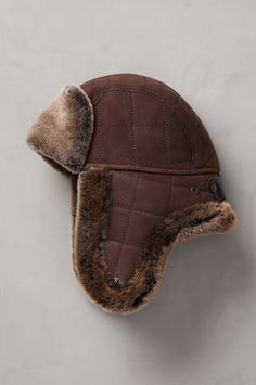 Handsome, durable, and incredibly insulating. The Hayes Trapper Hat in two-tone quilted shearling is a smart update of a timeless winter must-have. Entirely crafted of sheepskin, with the plush side in to keep your head warm and the rugged leather side out for wind-stopping protection, the Hayes stands up to the coldest days in style. Secure the snaps under the chin on freezing days and snap the earflaps up in milder temps for two great winter hats in one. Pair with our best-selling Hayes sheepskin coat for a complete look. Cossack Hat, Hats Cowboy, Fur Hats, Rugged Leather, Winter Must Haves, Trapper Hat, Dapper Style, Sheepskin Coat, Trapper Hats