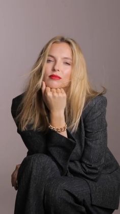 a woman with long blonde hair sitting down