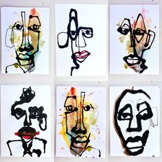 four different faces are drawn on white paper