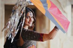 a woman holding an umbrella in her hand