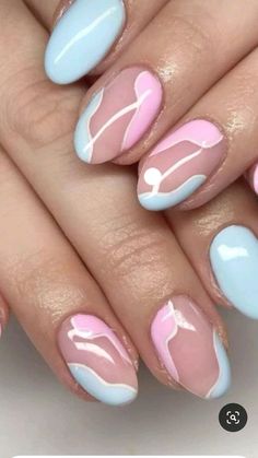 a woman's hands with pink and blue nail polishes on their nails, which are