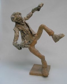 a figurine of a man with his legs spread out and holding a baseball bat