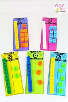 four different colored plastic pegs with numbers on them