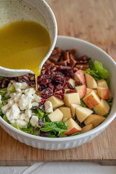 Autumn Salad ingredients in a bowl with apple cider vinaigrette being poured on it. Thanksgiving Salad Recipes, Thanksgiving Salad, Homemade Apple Cider, Delicious Thanksgiving