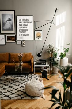 a living room filled with furniture and pictures on the wall