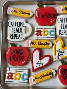 decorated cookies in the shape of letters and numbers on a cookie sheet with magnets