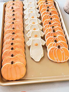 there are many decorated pumpkins on the cookie sheet