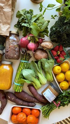 a table topped with lots of different fruits and vegetables