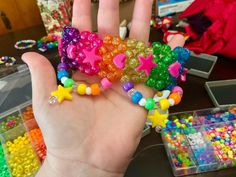 a person holding up some colorful beads in their hand