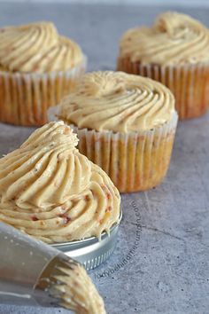 cupcakes with peanut butter frosting in a tin