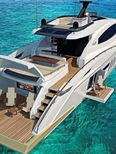 a large white boat floating on top of the ocean next to a dock and stairs