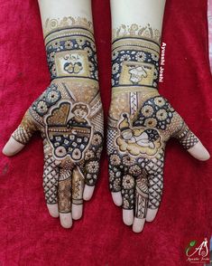 two hands with henna designs on them