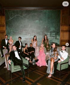 a group of people sitting on couches in front of a chalkboard with trees