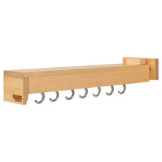 a wooden shelf with three hooks on it