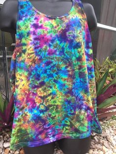 a woman's tank top that has been dyed with multicolored tie dye