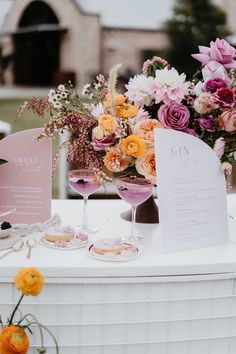 a table with flowers and wine glasses on it