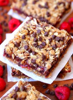 raspberry chocolate chip granola bars are stacked on top of each other and ready to be eaten