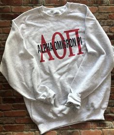 a white sweatshirt with the word aot printed on it in red and black letters