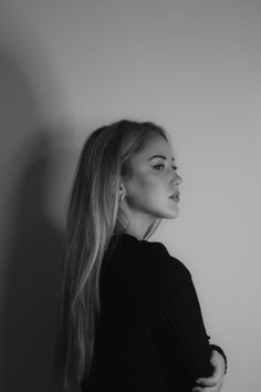 a black and white photo of a woman with long hair