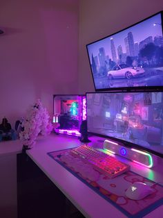 two computer monitors sitting on top of a desk next to a keyboard and mouse pad