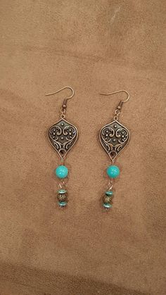 Dress these stunning earrings up or down for every day wear. Faux turquoise 8mm beads with teal spacers and a lovely brass plated focal drop complete the look. Turquoise Bohemian Earrings With Ear Wire, Bohemian Turquoise Earrings With Ear Wire, Vintage Turquoise Beaded Drop Earrings, Turquoise Drop Chandelier Earrings With Ear Wire, Bohemian Turquoise Teardrop Earrings For Jewelry Making, Turquoise Bohemian Beaded Earrings For Pierced Ears, Turquoise Teardrop Beaded Bohemian Earrings, Turquoise Chandelier Drop Earrings, Handmade Turquoise Teardrop Earrings With Round Beads