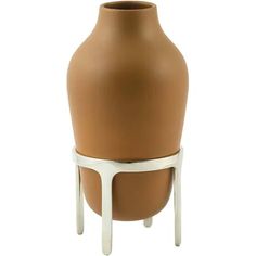 a brown and white vase sitting on top of a table