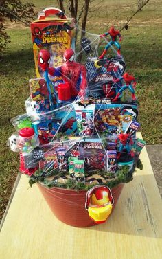 a large basket filled with toys on top of a wooden table next to a tree