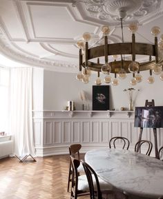 an elegant dining room with marble table and chairs