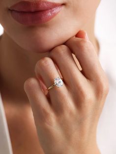 a close up of a person wearing a ring with a diamond on the middle finger