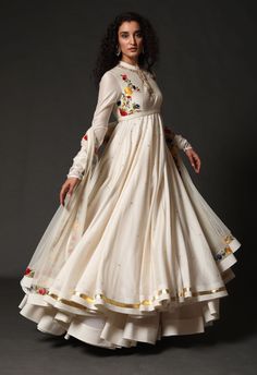 Editor's Note Chanderi Anarkali With Chanderi Dupatta Paired Up With Churidar Color: Ivory Fabric: Chanderi & Cotton Care: Dry Clean Only About the Designer Rohit Bal is intensely concerned with design as an art form. The designer draws on history, fantasy and folklore to create masterpieces that are desired by discerning aficionados around the globe. Rohit has a deep understanding of the psyche of the fashion world and it reflects in his collections that are intelligent, studied, imaginative an Luxury Embroidered Anarkali Churidar, Luxury Anarkali Set With Pallu, Luxury Anarkali Chikankari Embroidered Fabric, Luxury Anarkali Set With Zari Work For Puja, Luxury Anarkali Chinon Palazzo Set, Luxury Anarkali Choli With Resham Embroidery, Luxury Anarkali Churidar With Floral Print, Luxury Anarkali Salwar Kameez With Motifs, Luxury Cotton Anarkali Salwar Kameez