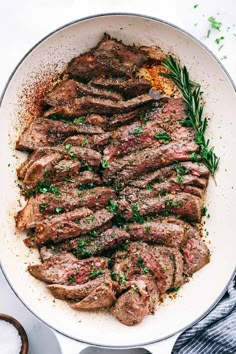 steak in a skillet with herbs and seasoning