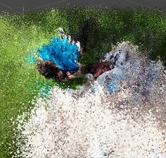 a person laying on the ground covered in blue and green powdered grass with their head down