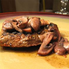 a piece of meat with mushrooms on top of it