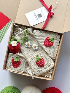 a box filled with crocheted items on top of a table