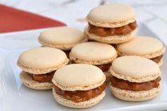 a white plate topped with mini sandwiches covered in jelly