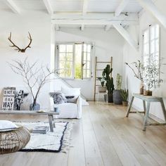 a living room with white walls and wooden floors