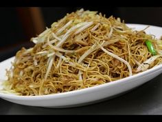 a white bowl filled with noodles and vegetables