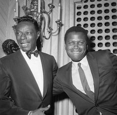 two men in tuxedos standing next to each other