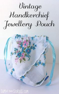 the vintage handkerheif jewelry pouch is made from fabric and has blue flowers on it