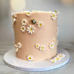 a pink cake with white flowers on it