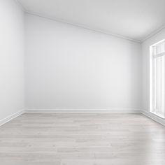 an empty room with white walls and wood floors