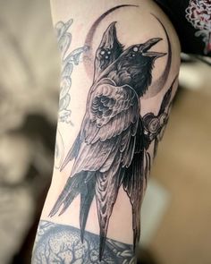 a bird sitting on top of a person's arm with the moon in the background