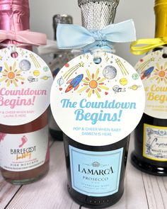 three bottles of condiments on a table with ribbons and tags attached to them