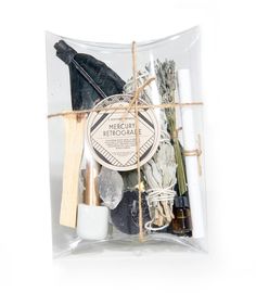 an assortment of natural items in a clear package on a white background with twine