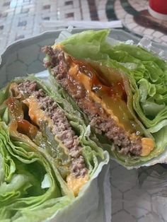 two lettuce wraps filled with meat and sauce