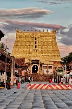 the entrance to a temple with people walking around